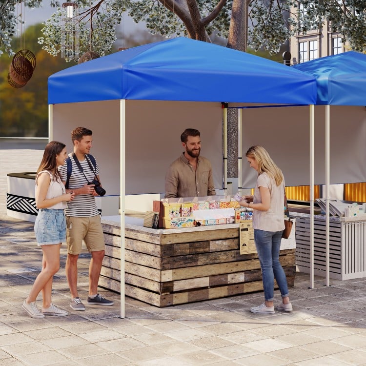 Pop-up canopy tent with blue top and half sidewall, ideal for outdoor events, street vending, and easy setup.