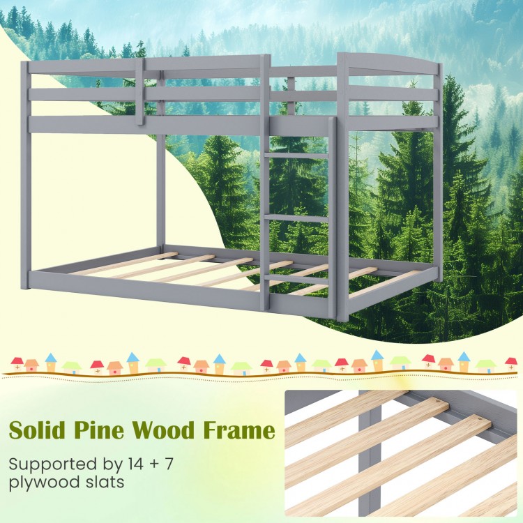 Full over full low-to-ground bunk bed in gray, solid pine wood frame with guardrails and integrated ladder for kids'.