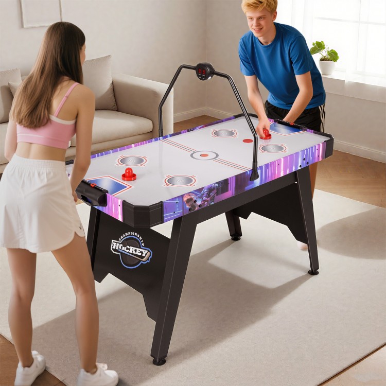 56-inch air hockey table with LED scoreboard, featuring two players in action, perfect for family fun and stability.