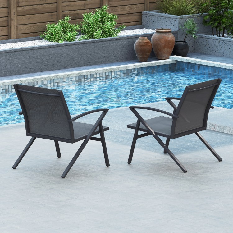 Two grey patio chairs with heavy-duty metal frames, positioned by a pool for outdoor relaxation.