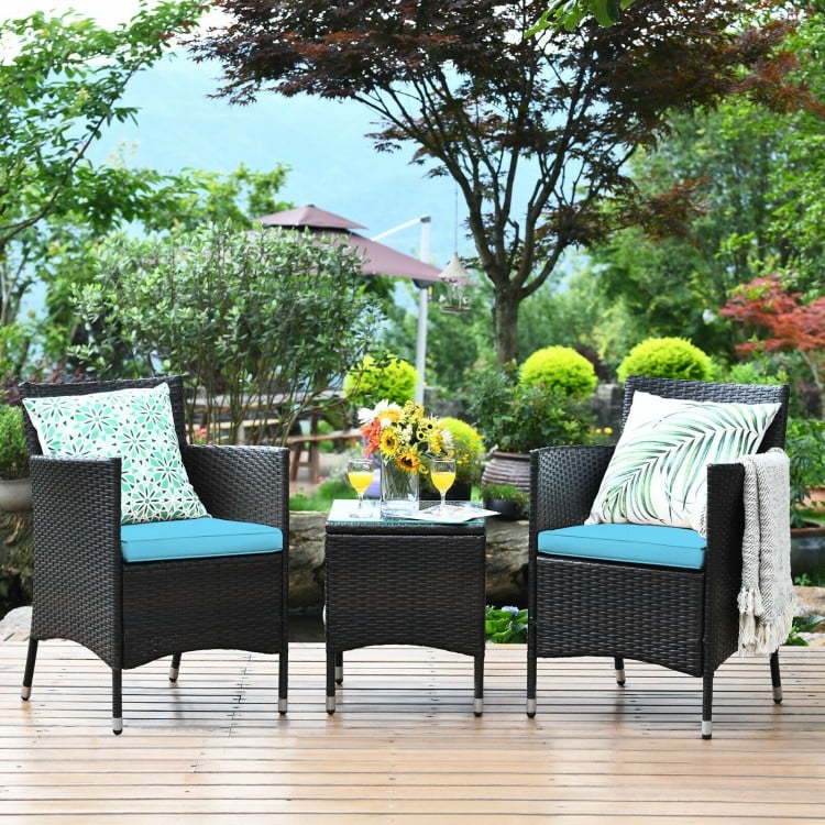 3-piece outdoor wicker rattan furniture set with blue cushions and tempered glass table, perfect for patio relaxation.