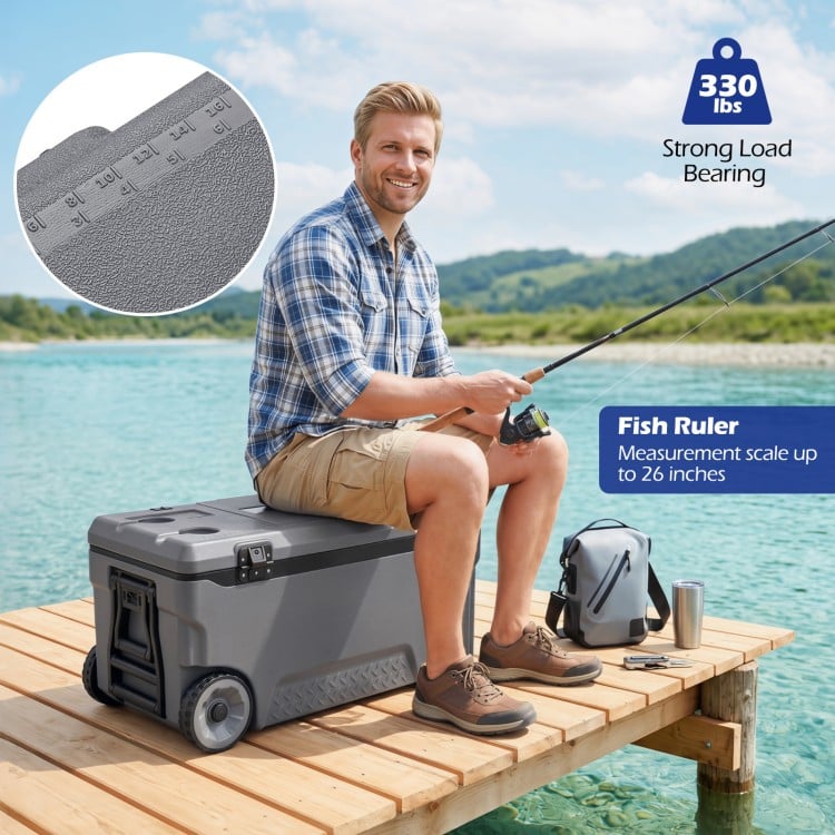 Portable 74 quart gray rolling cooler features a fish ruler, sturdy design, and is ideal for camping and fishing trips.