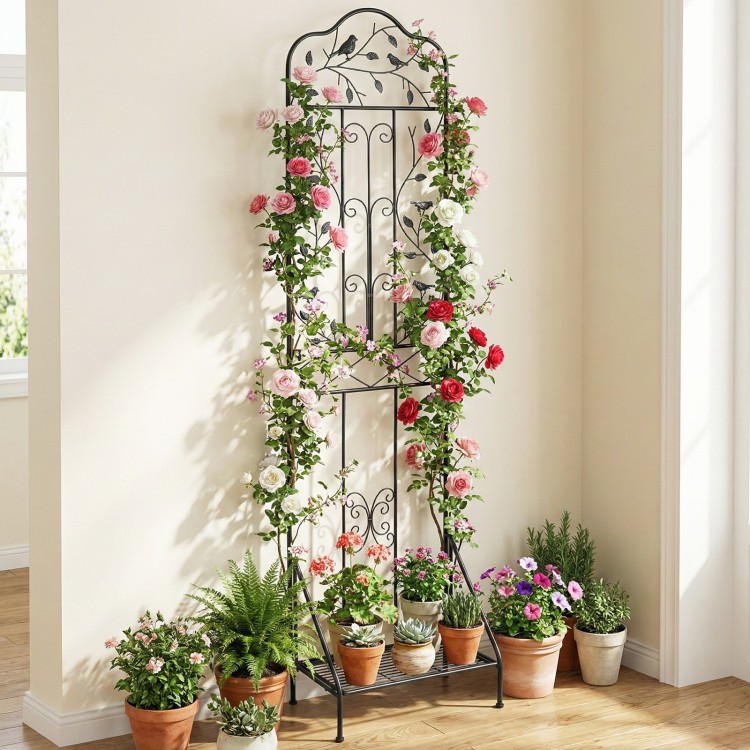 Freestanding black metal garden trellis with elegant bird design and foldable bottom shelf for potted plants and flowers.