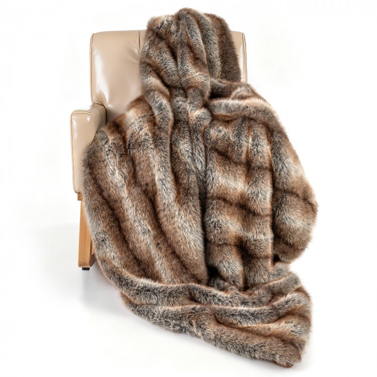 Luxurious brown faux fox fur blanket draped over a chair, featuring a soft texture and double-sided design for comfort.