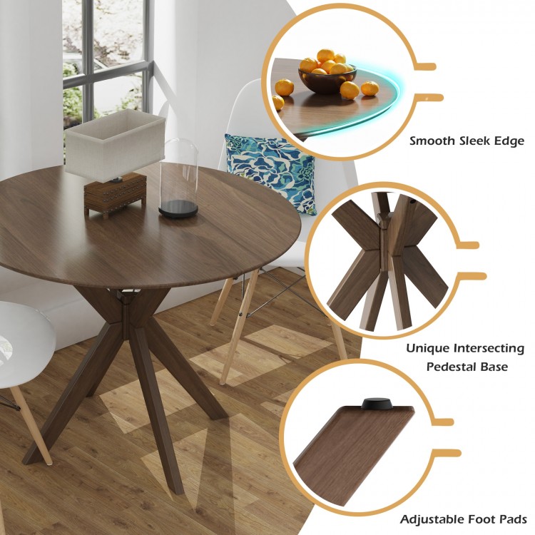Round wood dining table with intersecting pedestal base, smooth edge, and adjustable foot pads for stability.
