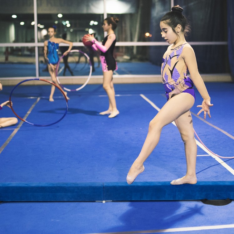 Blue 7 feet folding balance beam with handles, featuring a suede-like cover, ideal for gymnasts' training and.