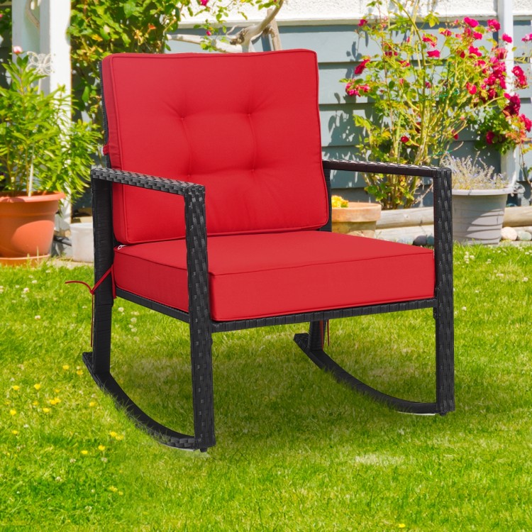 Red cushioned patio rattan rocking chair with sturdy metal frame, ideal for outdoor relaxation in garden or backyard.