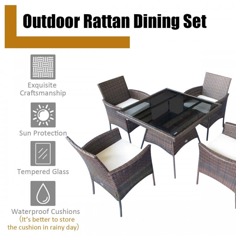 Outdoor rattan dining set featuring a glass-top table and four single sofas with removable cushions for patio.