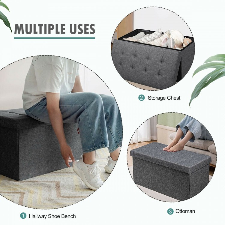 Foldable dark gray storage ottoman with padded seat, ideal for storing clothes and shoes in living room or entryway.