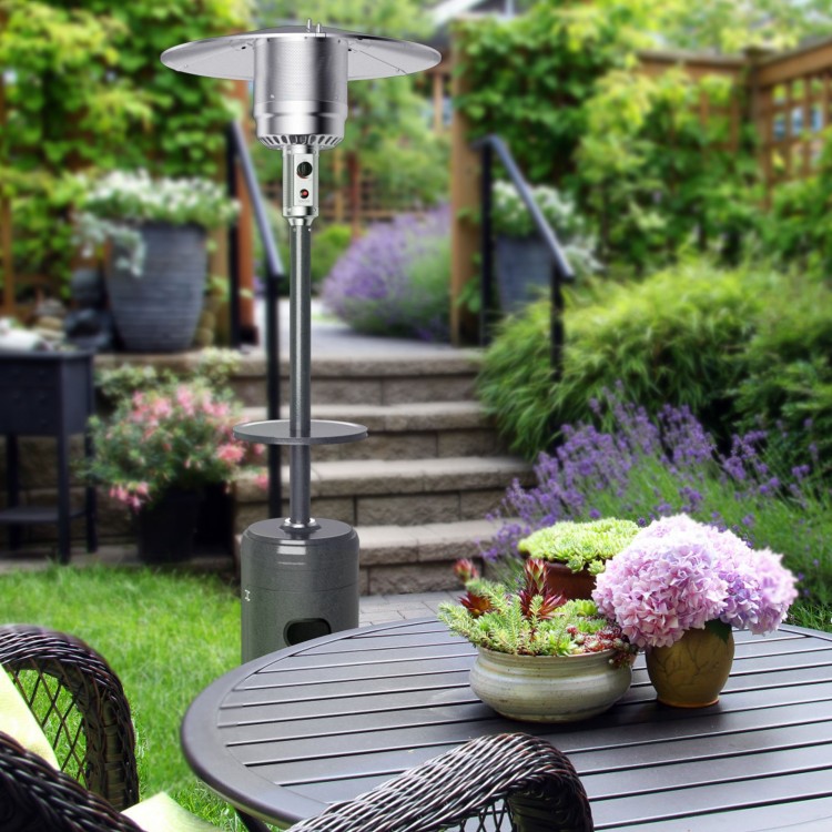 Standing propane outdoor heater in gray with table and wheels, providing warmth for patio gatherings.