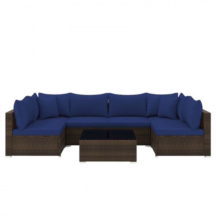 Sectional sofa set with navy cushions, made of PE rattan, includes coffee table, perfect for outdoor patio relaxation.