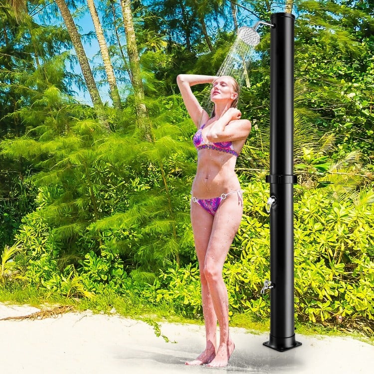 Solar-heated outdoor shower with 360° rotating shower head, black finish, perfect for beachside or garden use.