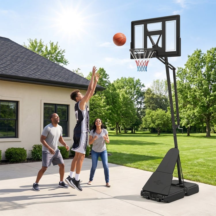 Height adjustable basketball goal system with shatterproof backboard, set at 7.7 ft for outdoor play and stability.
