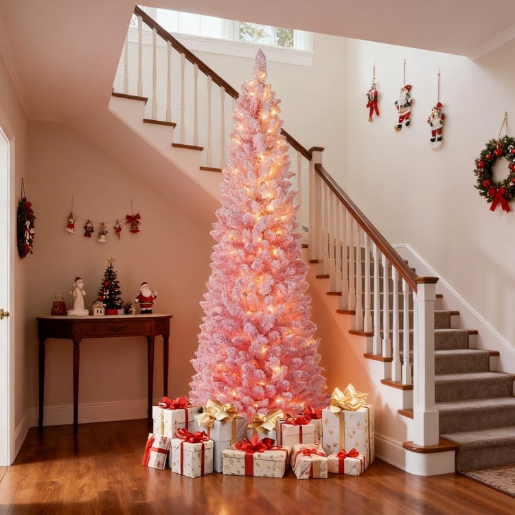 Snow-flocked 7 FT pink Christmas tree with 140 warm white LED lights, perfect for holiday decoration in any space.