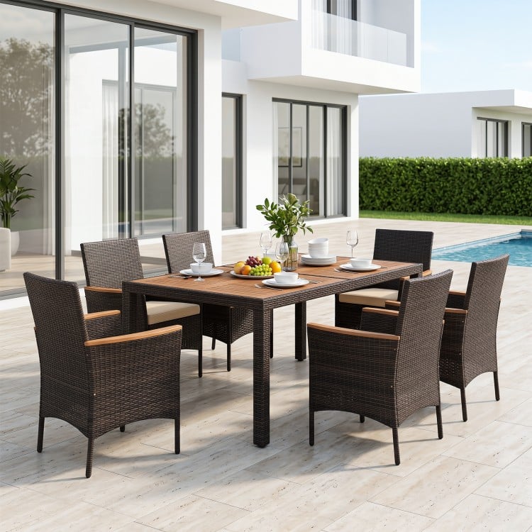 7-piece patio dining set featuring a wood tabletop, padded chairs, and hand-woven PE wicker for outdoor gatherings.