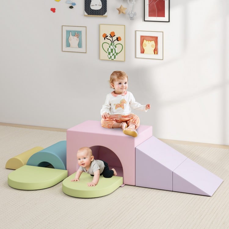 Soft foam toddler climbing blocks set in pink, featuring a slide and tunnel for active play and exploration.