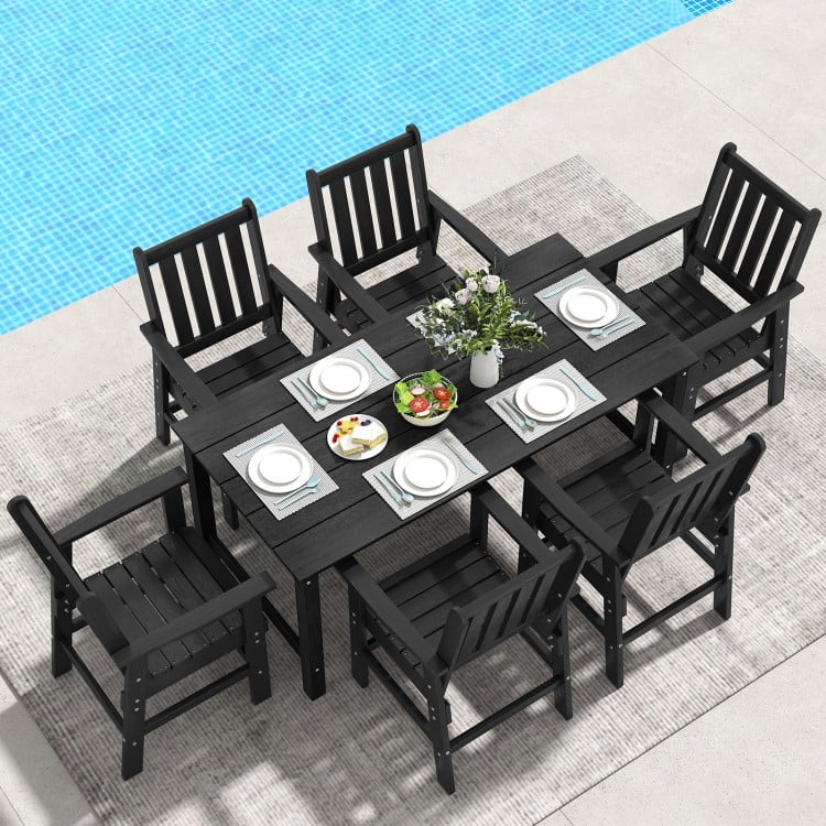 7-piece black patio dining set with HDPE table and chairs, featuring a large tabletop and rustic wood-like surface.