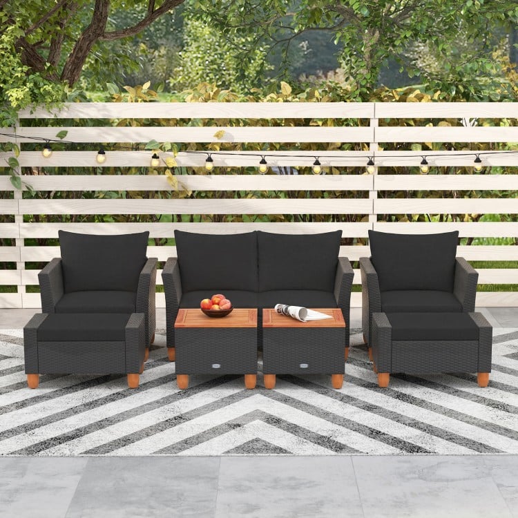 7-piece patio furniture set featuring black PE rattan sectional sofa, armchairs, and acacia wood table for outdoor.