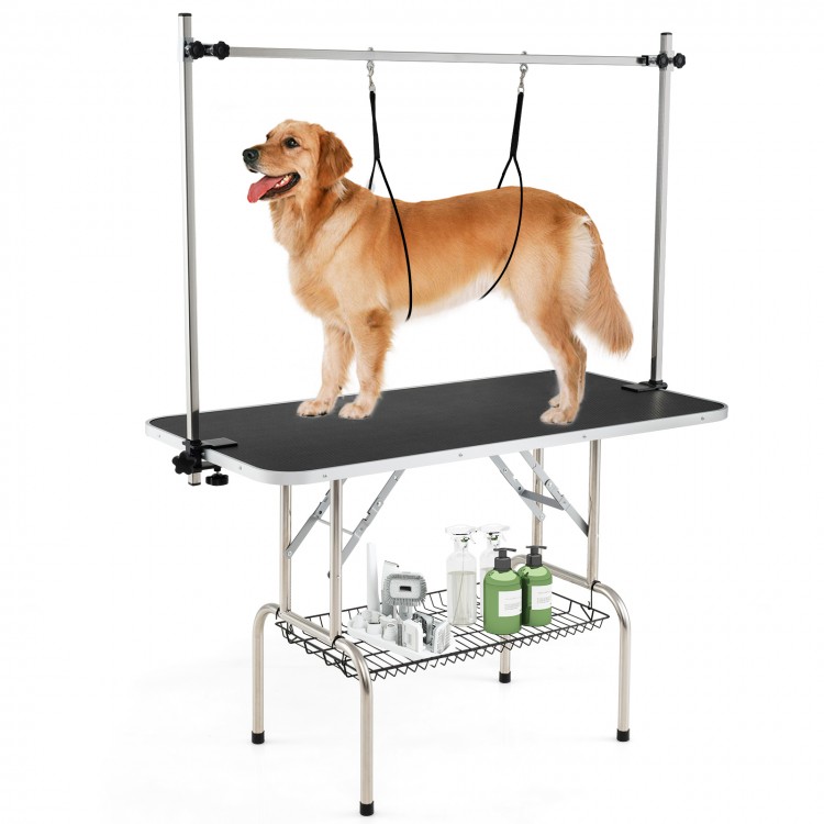 Foldable dog grooming table with height adjustable arms, non-slip waterproof surface, and storage mesh tray for pet.