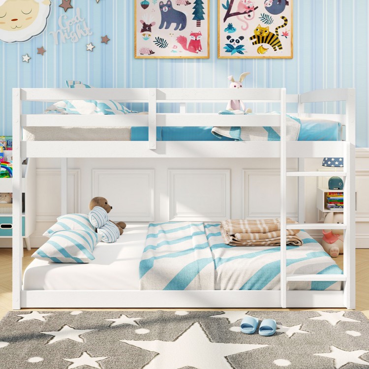 Low-to-ground white full over full bunk bed with safety guardrails and integrated ladder, ideal for kids' rooms.
