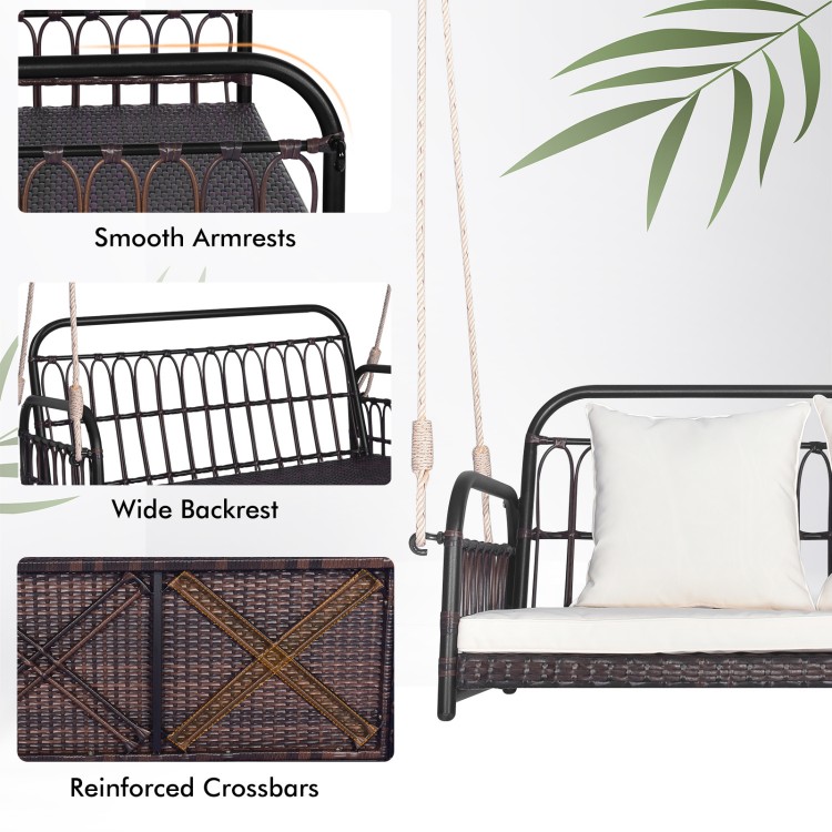 Wicker hanging porch swing with smooth armrests, wide backrest, and reinforced crossbars, includes removable cushions.