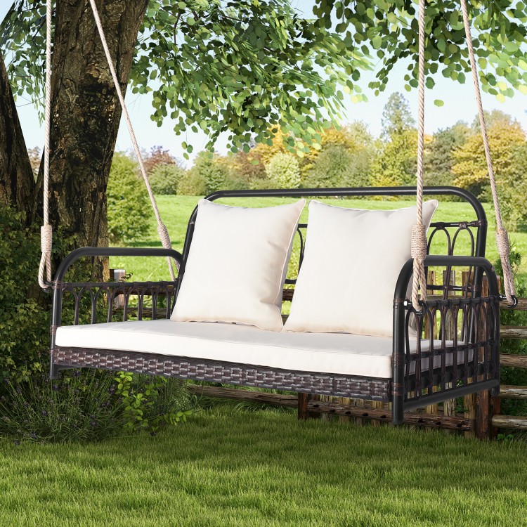 Wicker hanging porch swing with white cushions, durable PE wicker, seats 2, ideal for outdoor relaxation in garden or.