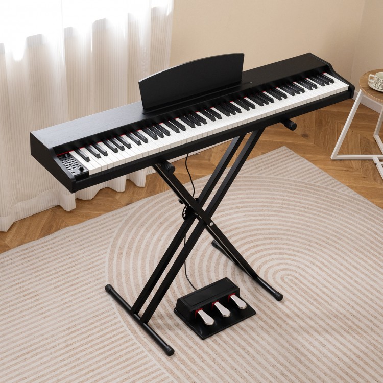 88-key keyboard piano set in black with adjustable stand, featuring dual speakers and removable music stand for.