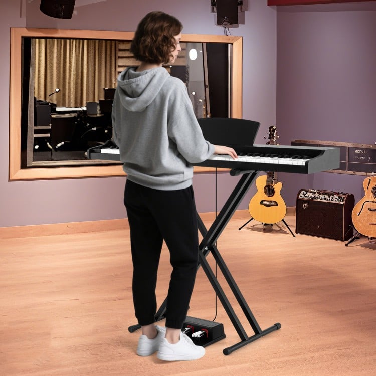 88-key keyboard piano set with adjustable stand, featuring dual speakers and removable music stand for versatile use.