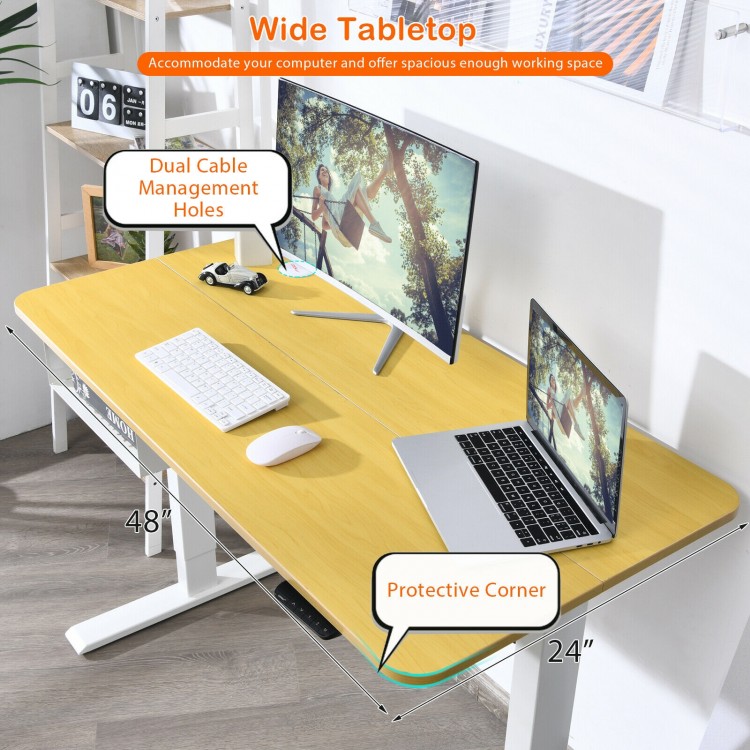 Wide 48-inch electric standing desk with dual cable management holes and protective corners for organized workspace.
