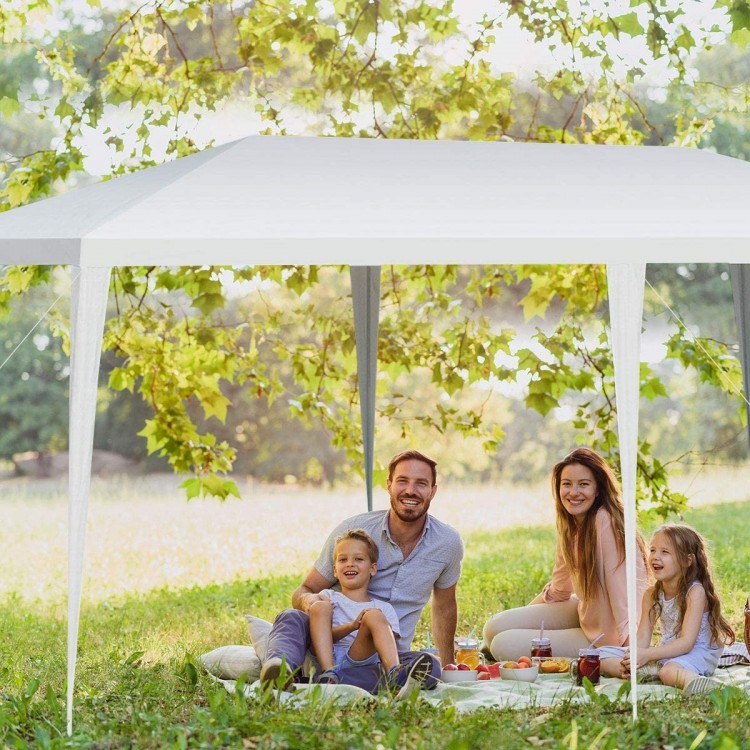 Bright white 10 x 20 feet waterproof canopy tent providing shade for a family picnic in a lush outdoor setting.