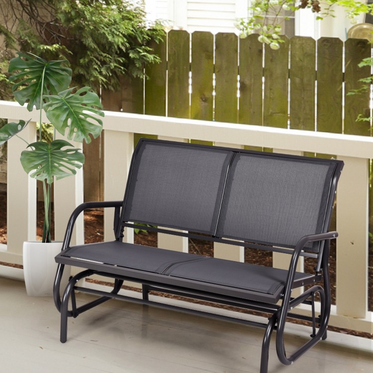 Gray swing glider chair with curved backrest and armrests, perfect for relaxing in outdoor patios or backyards.