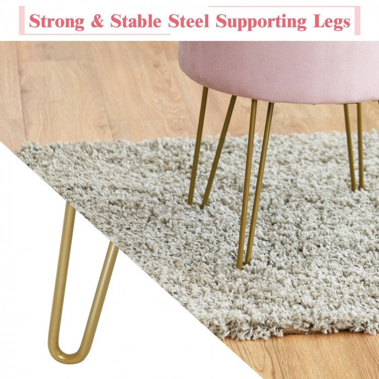 Close-up of the golden metal legs of a pink velvet storage ottoman, showcasing strong support for elegant decor.
