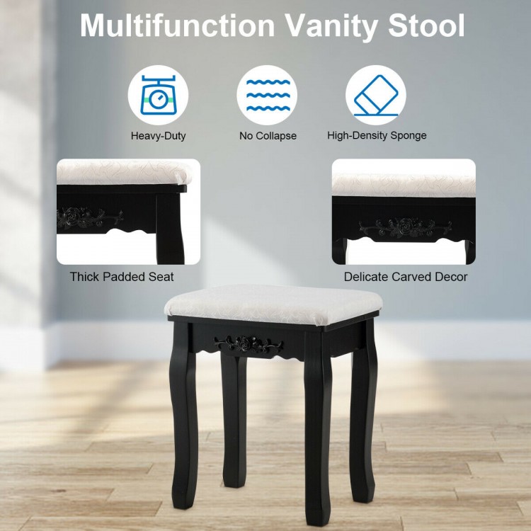 Cushioned vanity stool with delicate carved decor, designed for comfort and stability in a makeup dressing table setup.