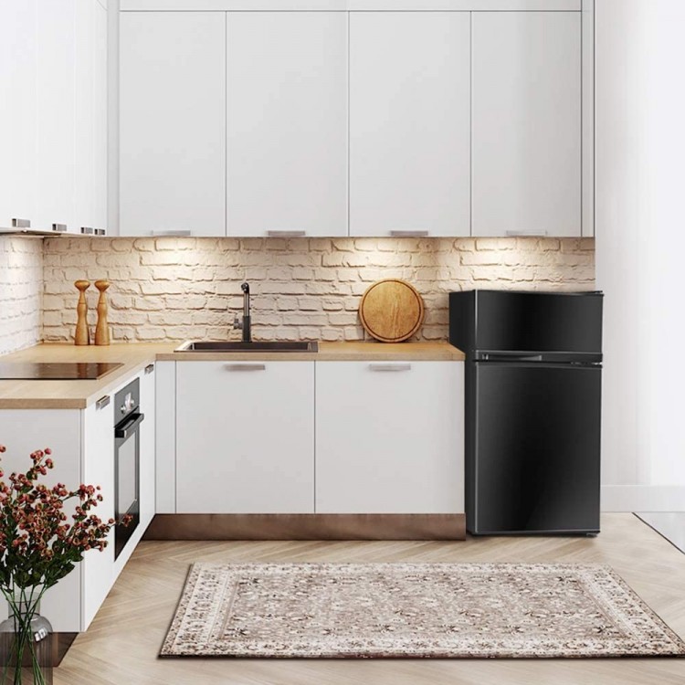 Compact black refrigerator with integrated door handle, adjustable shelves, and door bins, perfect for small spaces.