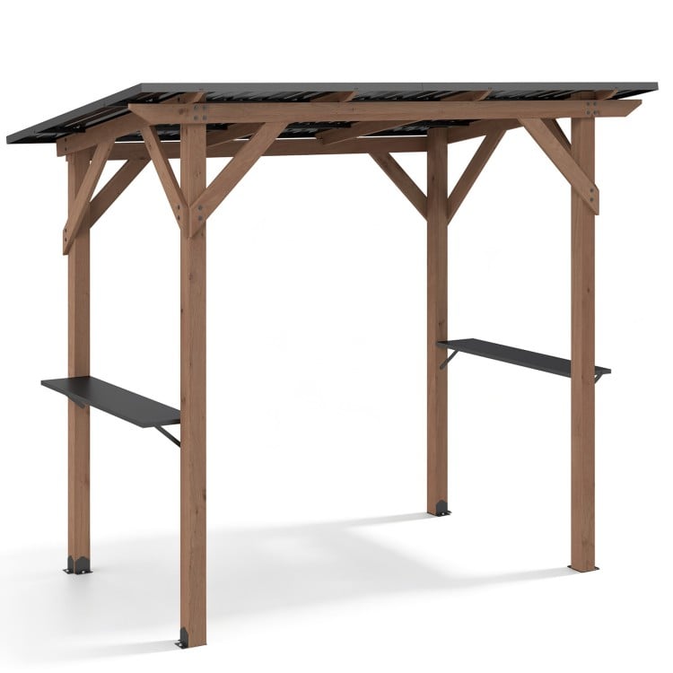 Cedar wood BBQ gazebo with a sloped metal roof and two side serving shelves for outdoor cooking and gatherings.