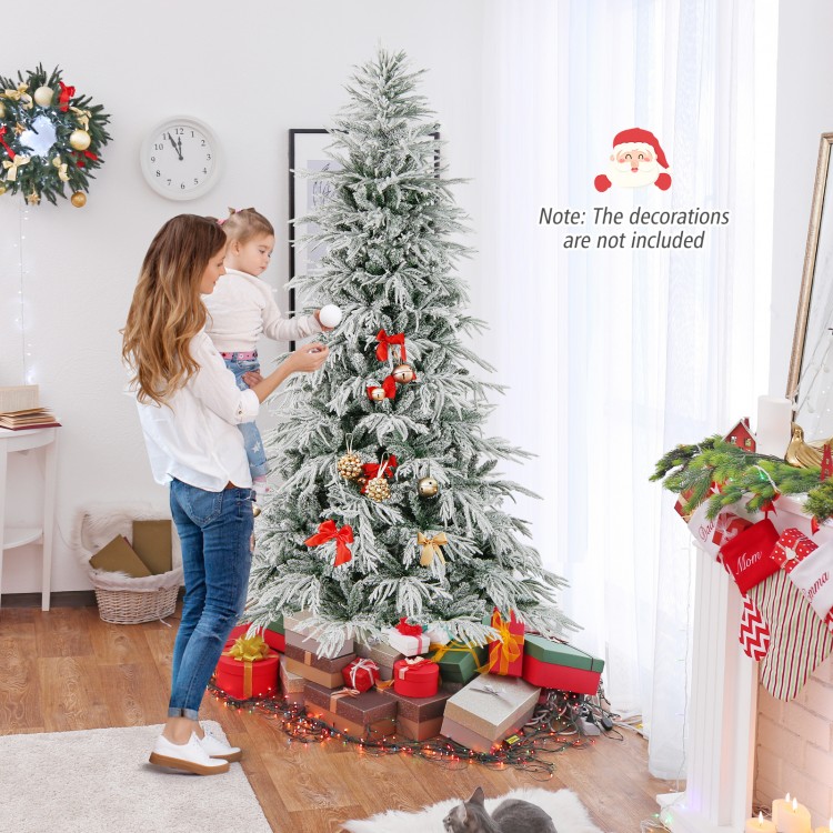 Snow-flocked 8-foot artificial Christmas tree with warm white LED lights, perfect for festive holiday decor.