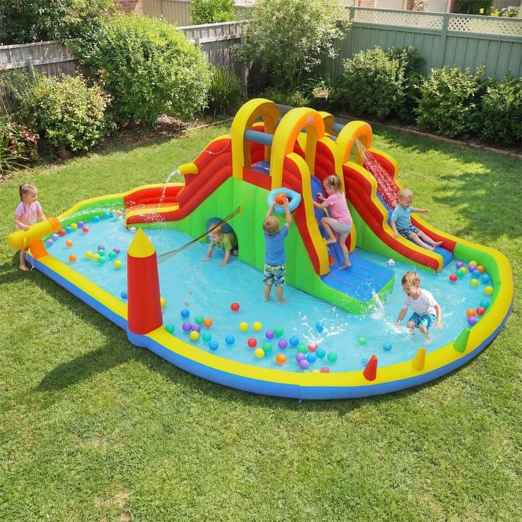 Giant bounce house with two slides, climbing walls, and splash pool for kids' yard parties and summer fun.