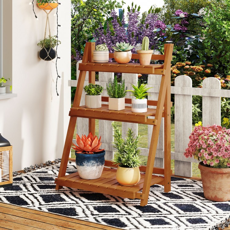 Foldable 3-tier solid wood plant stand with potted plants, ideal for patio or balcony display and optimal sunlight.