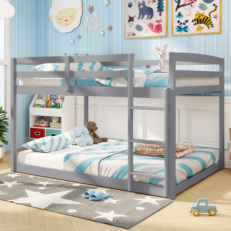 Gray full over full low-to-ground bunk bed with solid wood frame, guardrails, and integrated ladder for kids' safety.