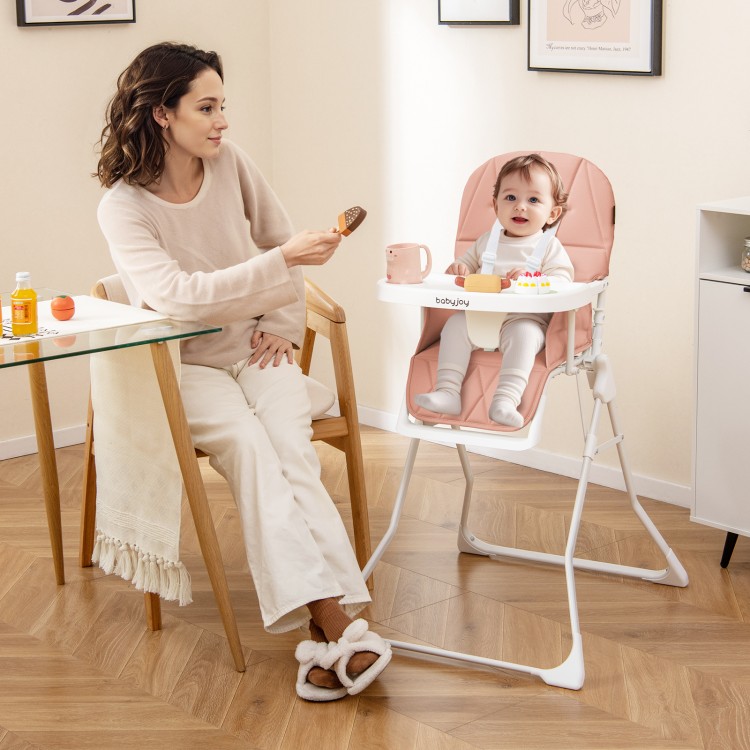 Compact pink highchair with removable tray, adjustable footrest, and safety harness for convenient feeding.
