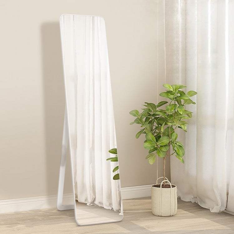 Frameless floor mirror in white, showcasing its sleek design and U-shaped bracket for stable standing in any room.