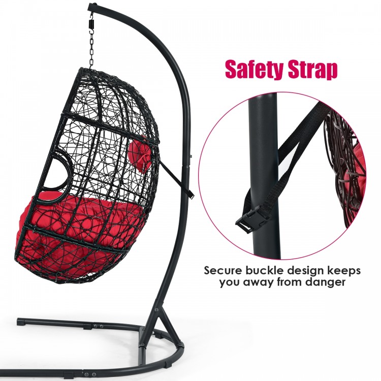 Hanging cushioned hammock chair with stand in red, featuring a safety strap for secure use and enhanced stability.