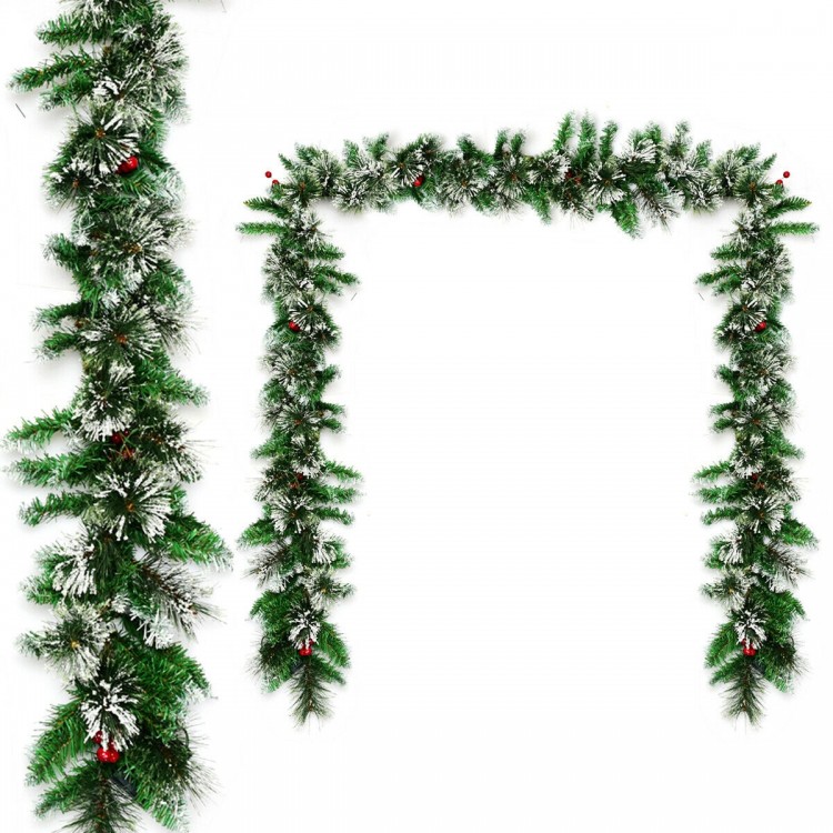 9-foot pre-lit Christmas garland with snow-flocked tips and red berries, featuring 50 LED lights for festive indoor or.