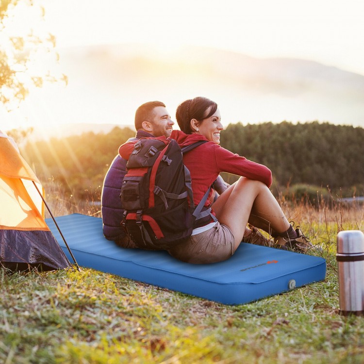 Self-inflating blue camping sleeping mattress with a couple relaxing outdoors, ideal for camping and travel.