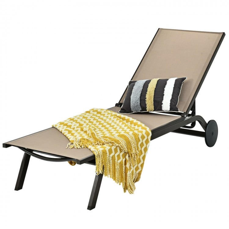 Adjustable brown aluminum lounge chair with a cozy blanket and pillow, ideal for relaxing on the patio or balcony.