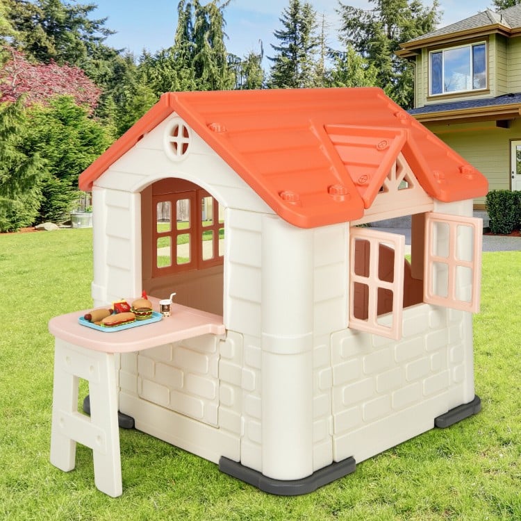 Kid’s playhouse with pink roof, windows, and table, made from durable HDPE for indoor and outdoor fun.