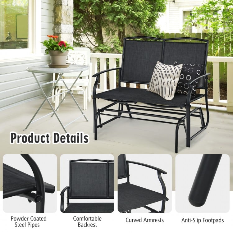 Black iron patio rocking chair with comfortable backrest and curved armrests, perfect for outdoor relaxation.