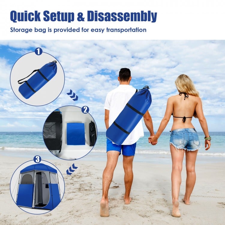 Double-room camping toilet tent in blue, featuring a portable storage bag for easy transport and setup at the beach.