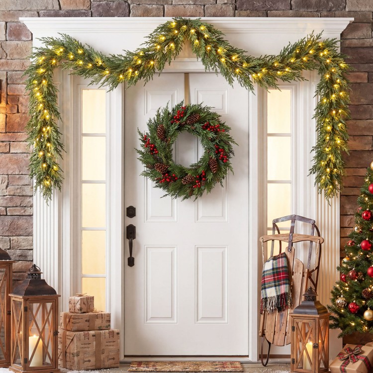 9 FT pre-lit artificial cypress Christmas garland with 50 warm white LED lights, perfect for front door decoration.