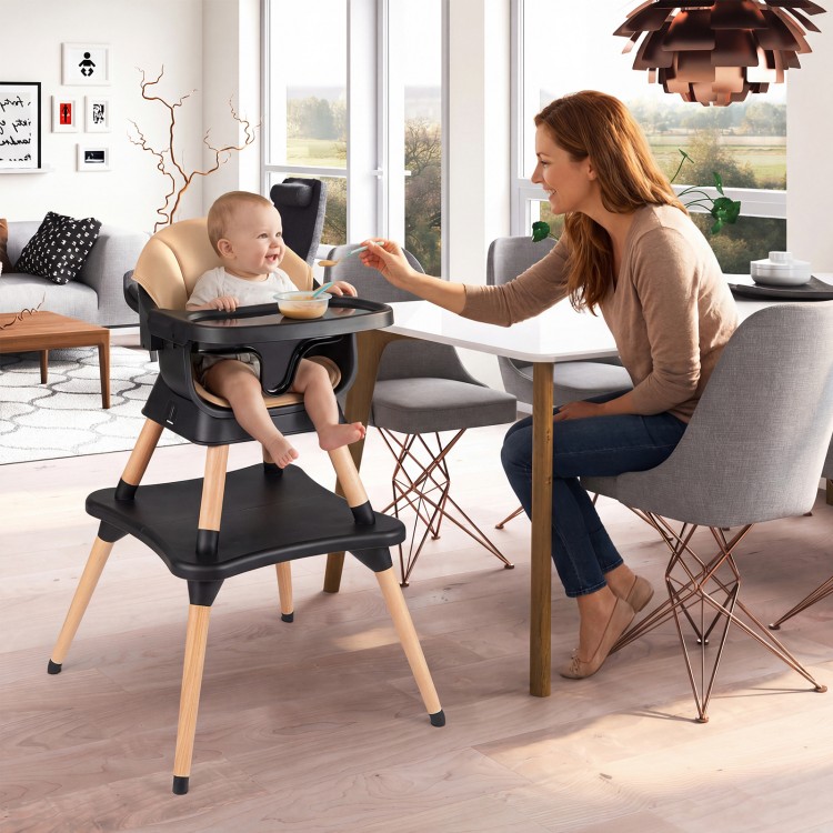 Convertible high chair in black with solid wood legs, featuring a removable cushion and adjustable tray for babies.